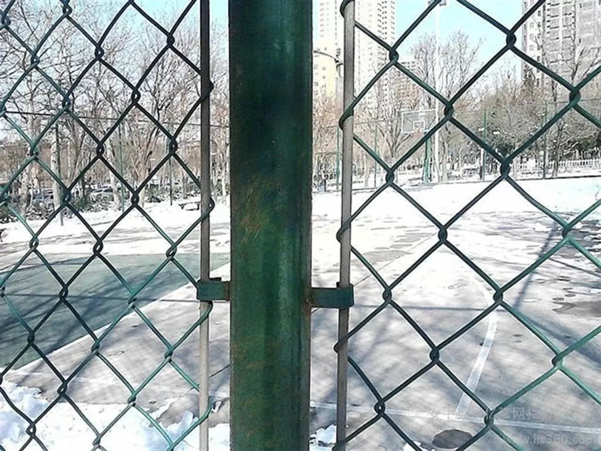 Woven chain-link mesh fence panels standing in a row on their posts