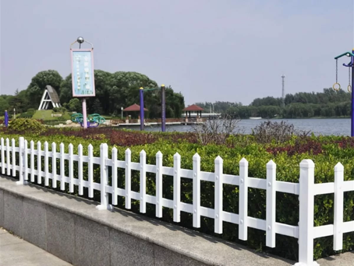 Low planter railing around a planted area on a street